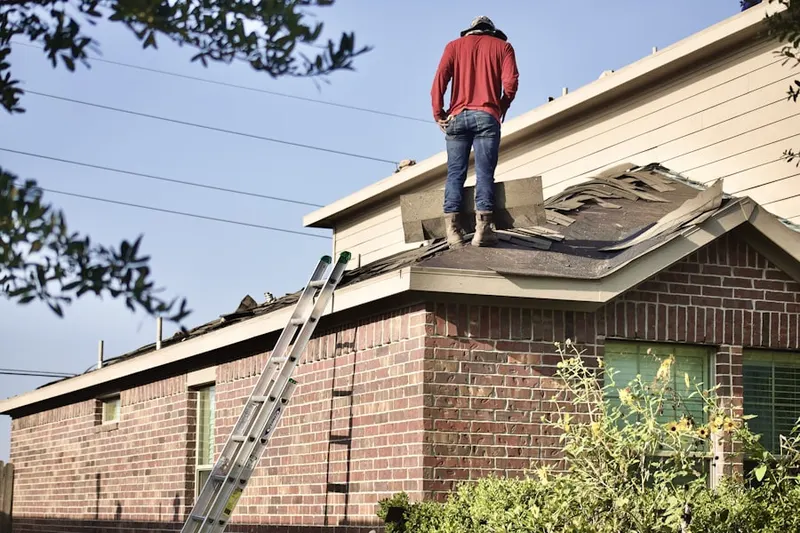 Professional roofer working on a residential roof in Twin Lakes Village